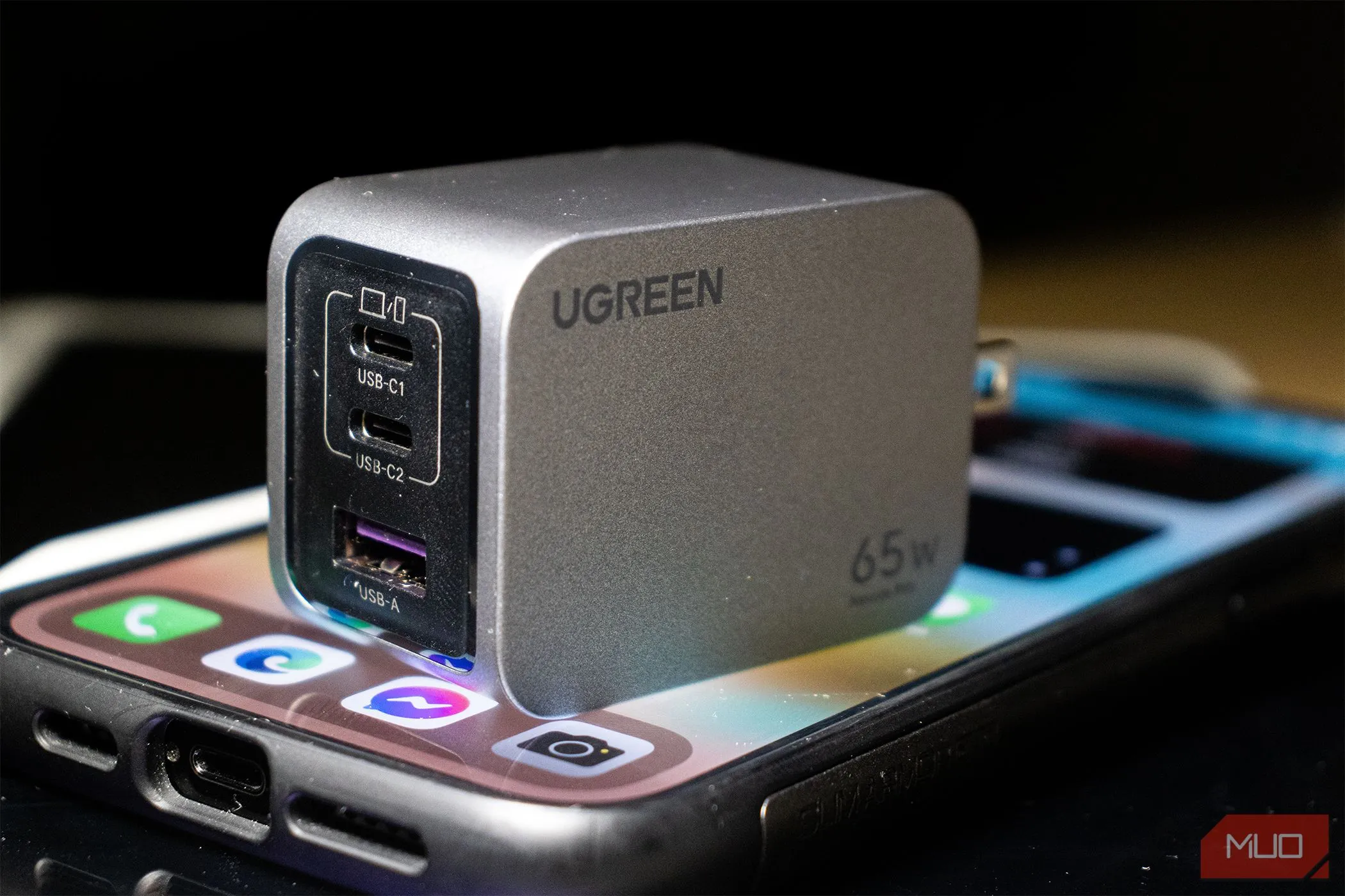 Củ sạc Ugreen Nexode Pro 65W đang sạc cho điện thoại iPhone 14 Pro Max, minh họa tầm quan trọng của việc giữ phụ kiện gốc