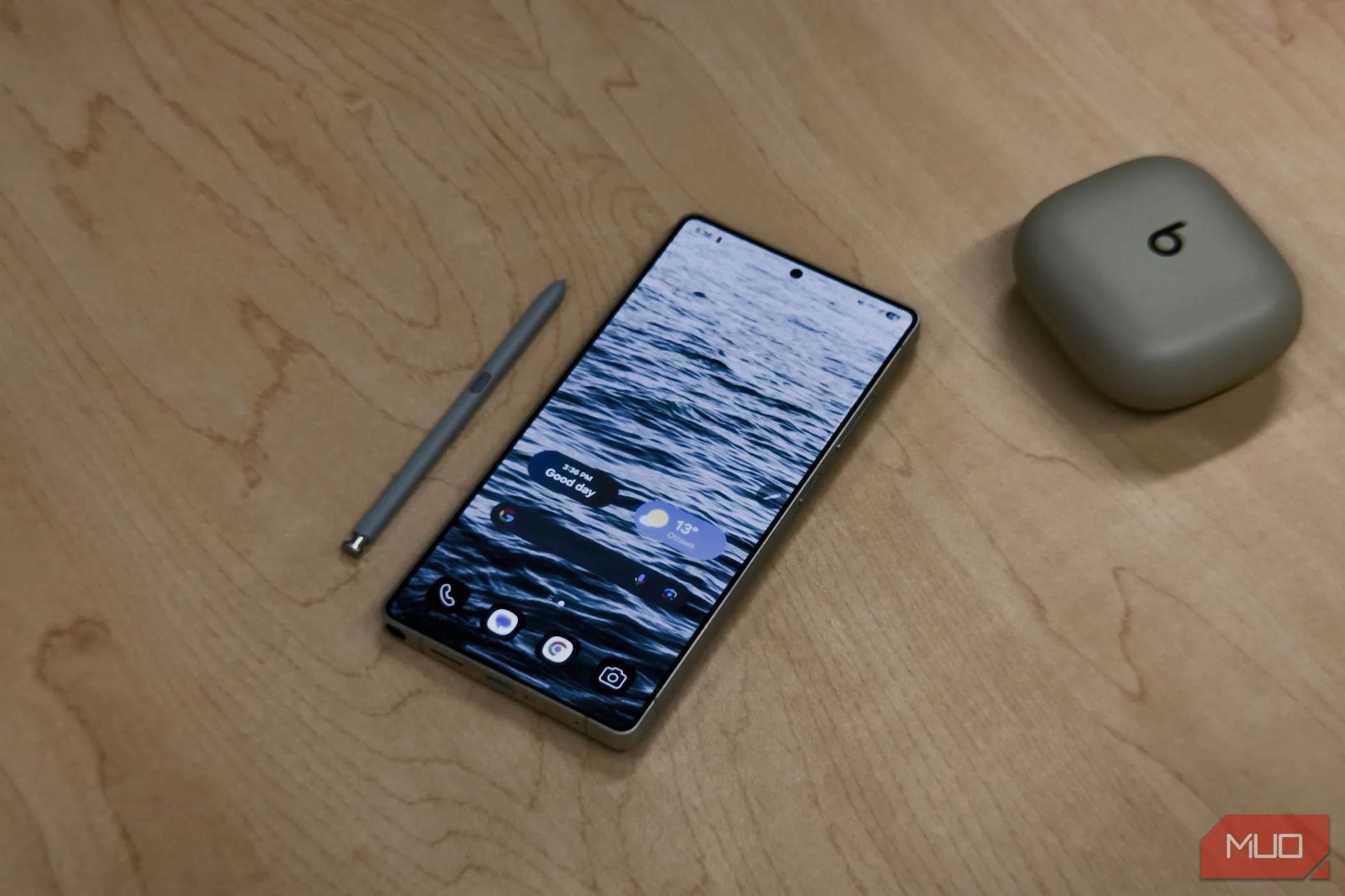 Điện thoại Samsung Galaxy S25 Ultra màu đen với bút S-Pen được rút ra, đặt trên bàn gỗ
